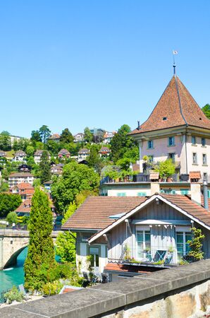 Bern, Switzerland - August 14, 2019: Historical buildings located along turquoise Aare River in the historical old town of the Swiss capital. Captured on vertical photography during sunny summer day.のeditorial素材