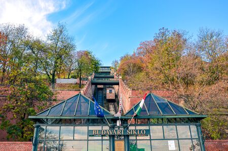 Budapest, Hungary - Nov 6, 2019: Cable car, public funicular train leading to the Buda Castle on the hill in the Hungarian capital. Tram tracks in the narrow corridor leading uphill. Transportation.のeditorial素材