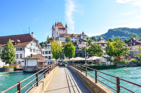 Thun, Switzerland - August 8, 2019: Amazing cityscape of historical city Thun. Located not far from the Swiss Alps. The dominant is the famous Thun castle. Bridge over turquoise Aare river.のeditorial素材