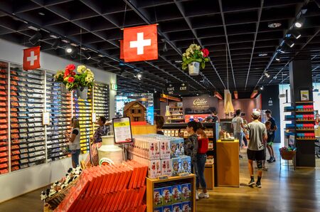 Broc, Switzerland - July 27, 2019: Visitors of the famous Cailler chocolate factory buying chocolate souvenirs in the local shop. People choosing Swiss chocolates in the factory store.のeditorial素材