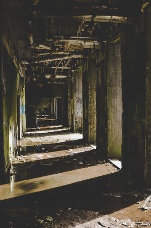 Sete Cidades, Azores, Portugal - Jan 12, 2020: Abandoned hotel building on the famous viewpoint on the Portuguese islands. Empty concrete building construction interior. Shadows and sunlight.のeditorial素材