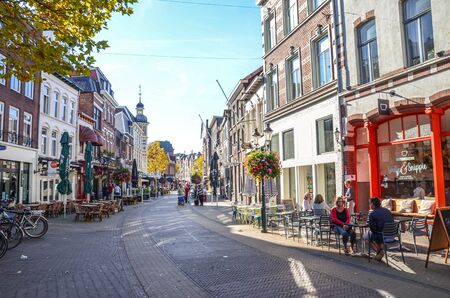 Venlo, Limburg, Netherlands - October 13, 2018: Street with cafes, restaurants, and bars in the historical center of the Dutch city. People walking on the street and sitting in the outside gardens.のeditorial素材