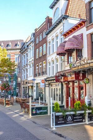 Venlo, Limburg, Netherlands - October 13, 2018: Street with cafes, restaurants, and bars in the historical center of the Dutch city. Traditional Dutch houses, vertical photo.のeditorial素材