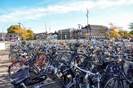 Venlo, Limburg, Netherlands - October 13, 2018: Rows of parked bicycles in the Dutch city close to the main train station. City biking. Eco-friendly means of transport.のeditorial素材