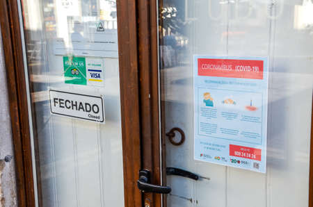 Faro, Portugal - March 16, 2020: Closed front door of the restaurant with coronavirus safety...