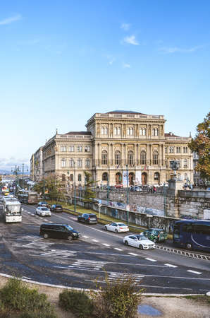 Budapest, Hungary - Nov 6, 2019: Busy road with cars in the city center of the Hungarian capital. The house of the Hungarian Academy of Sciences, MTA in the background. Vertical picture.のeditorial素材