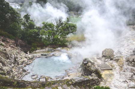 Furnas, Sao Miguel, Azores, Portugal - Jan 13, 2020: Volcanic hot springs in Portuguese Furnas. Geothermal sulphur spring. Steam surrounding the water pools.のeditorial素材