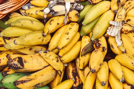 Clusters of ripe yellow bananas photographed on a fruit market. Overripe banana. Tropical fruits. Healthy lifestyle concept, source of vitamins.の写真素材