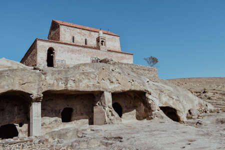 The Uplistsikhe cave complex near Gori, Georgia. Three-nave basilica on the rock. Ancient rock-hewn town in eastern Georgia. Georgian gourist landmarkの写真素材