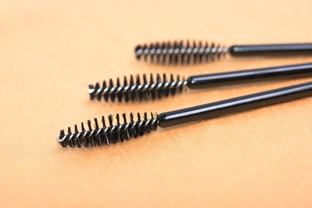 a three black  mascara brushes