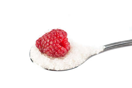 a raspberries on a spoon with sugarの写真素材