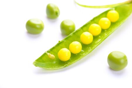 green peas and vitamin  isolated on a white backgroundの写真素材