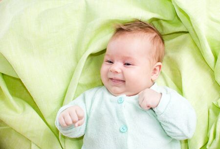 Newborn baby on green background