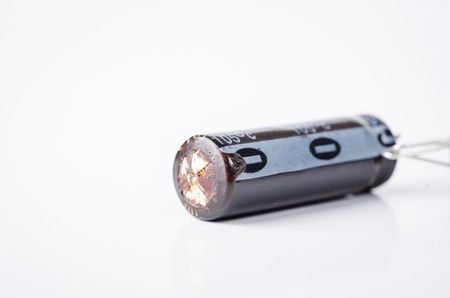 a bad capacitor isolated on whiteの写真素材