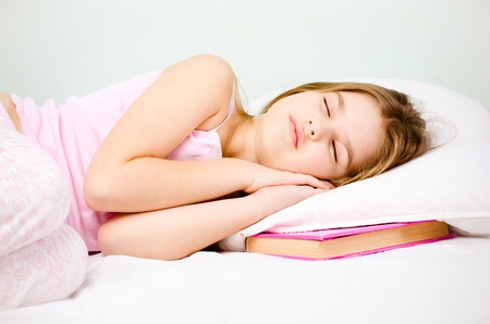young girl sleep with pink book