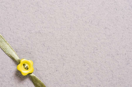 texture paper and ribbon with flower button and copy space