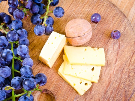 cheese on wooden board and nutの写真素材