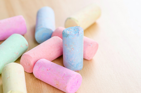 colorful chalk on wooden board