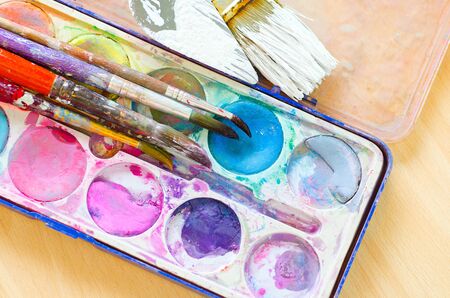 palette with watercolor ink and brush
