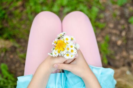 girl with a bouquet in the handsの写真素材
