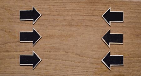 wood derection arrow with tag on wood backgroundの写真素材