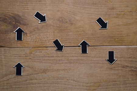 wood derection arrow with tag on wood backgroundの写真素材