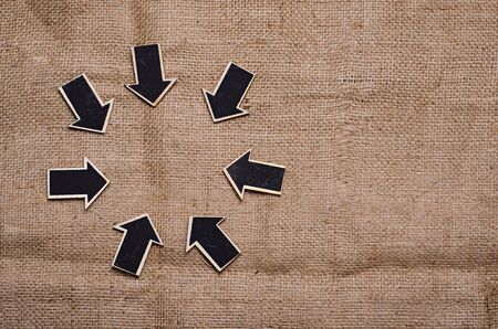 wood derection arrow with tag on sack backgroundの写真素材