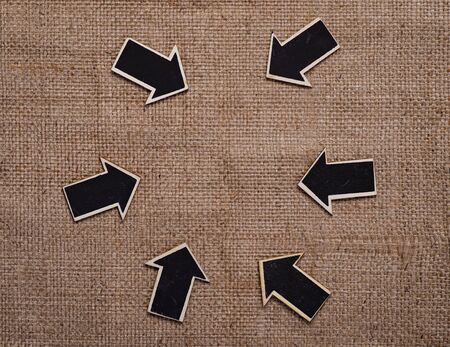 wood derection arrow with tag on sack backgroundの写真素材