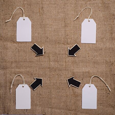 wood derection arrow with tag on sack backgroundの写真素材