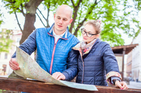 Young fashion elegant stylish couple, travel by old European cities, looking way on the map, smileの写真素材