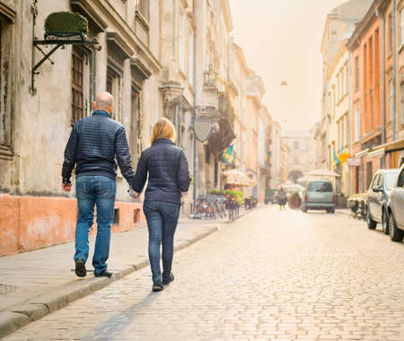 Young fashion elegant stylish couple walk  on streets of european city in summer morningの写真素材