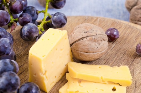 a slice cheese and nut on wooden boardの写真素材