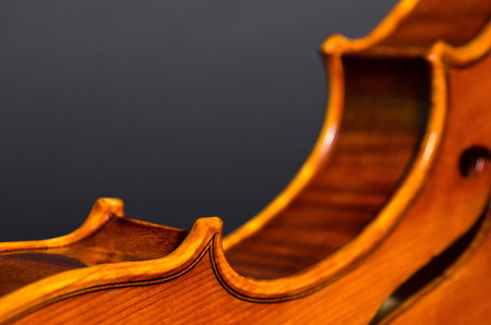 wooden violin part on black background, macro, focus on front cornerの写真素材