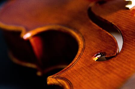 wooden violin part on black background, macroの写真素材