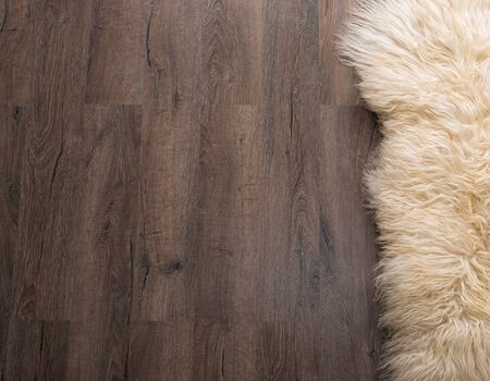 Decorative fur carpet on wood floor backgroundの写真素材