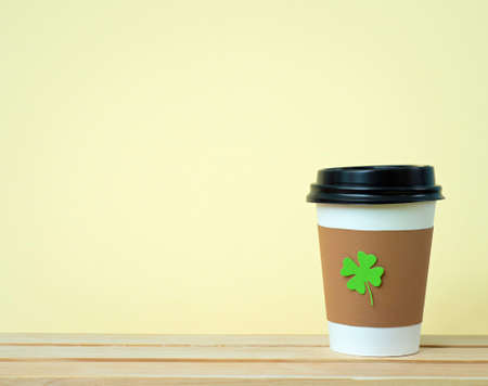 take away cup with cut and pasted green shamrock symbolの写真素材