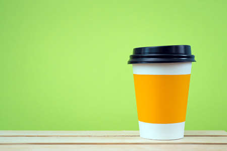 Paper cup with Sleeve on green backgroundの写真素材