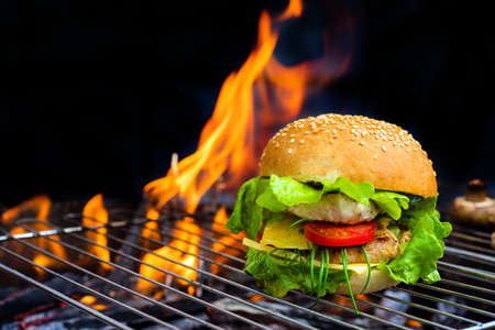 hamburger with grilled meat and cheese on a barbecueの写真素材