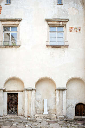 brick wall of old castle with windowの写真素材