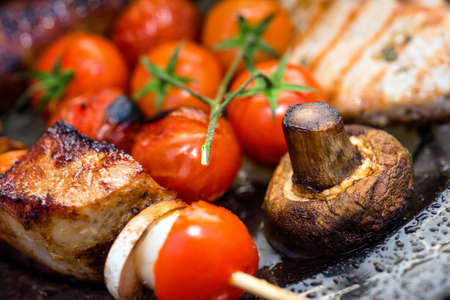 Raw Fresh Bloody Strip Steak, Tomatoes And Mushrooms On Hot Grill. Flames Of Fire On The Backgroundの写真素材