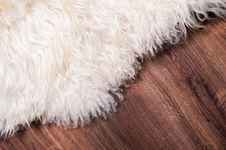 Decorative fur carpet on wood floor backgroundの写真素材