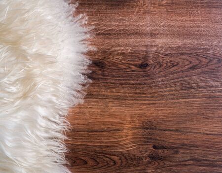 Decorative fur carpet on wood floor backgroundの写真素材