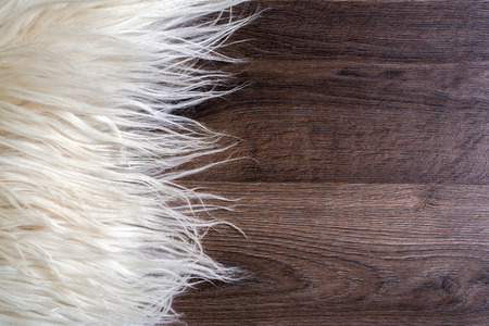 Decorative fur carpet on wood floor backgroundの写真素材