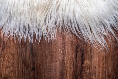 Decorative fur carpet on wood floor backgroundの写真素材