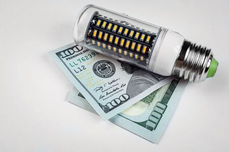 LED light bulb and money on white background. Eco conceptの写真素材