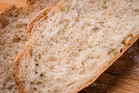 slicedof fresh bread on brown wooden table