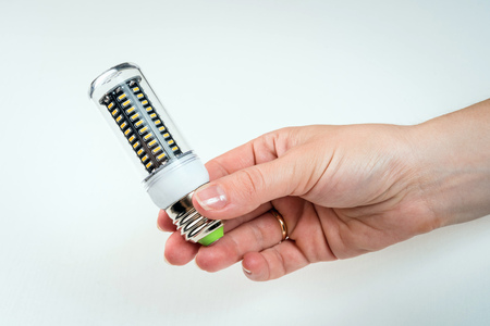 LED bulb in hand. on white background Eco conceptの写真素材