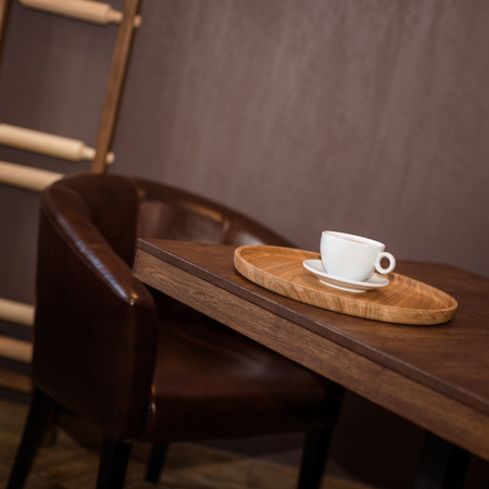 A cup of coffee in cafe. a white cup on wooden backgroundの写真素材