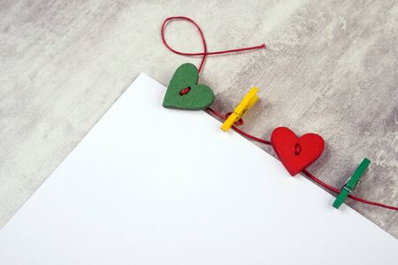 empty notepad with hearts on wooden surface