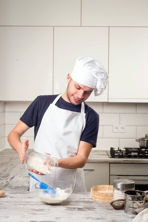 Portrait of a male chef cook preparation pastry on a kitchenの写真素材